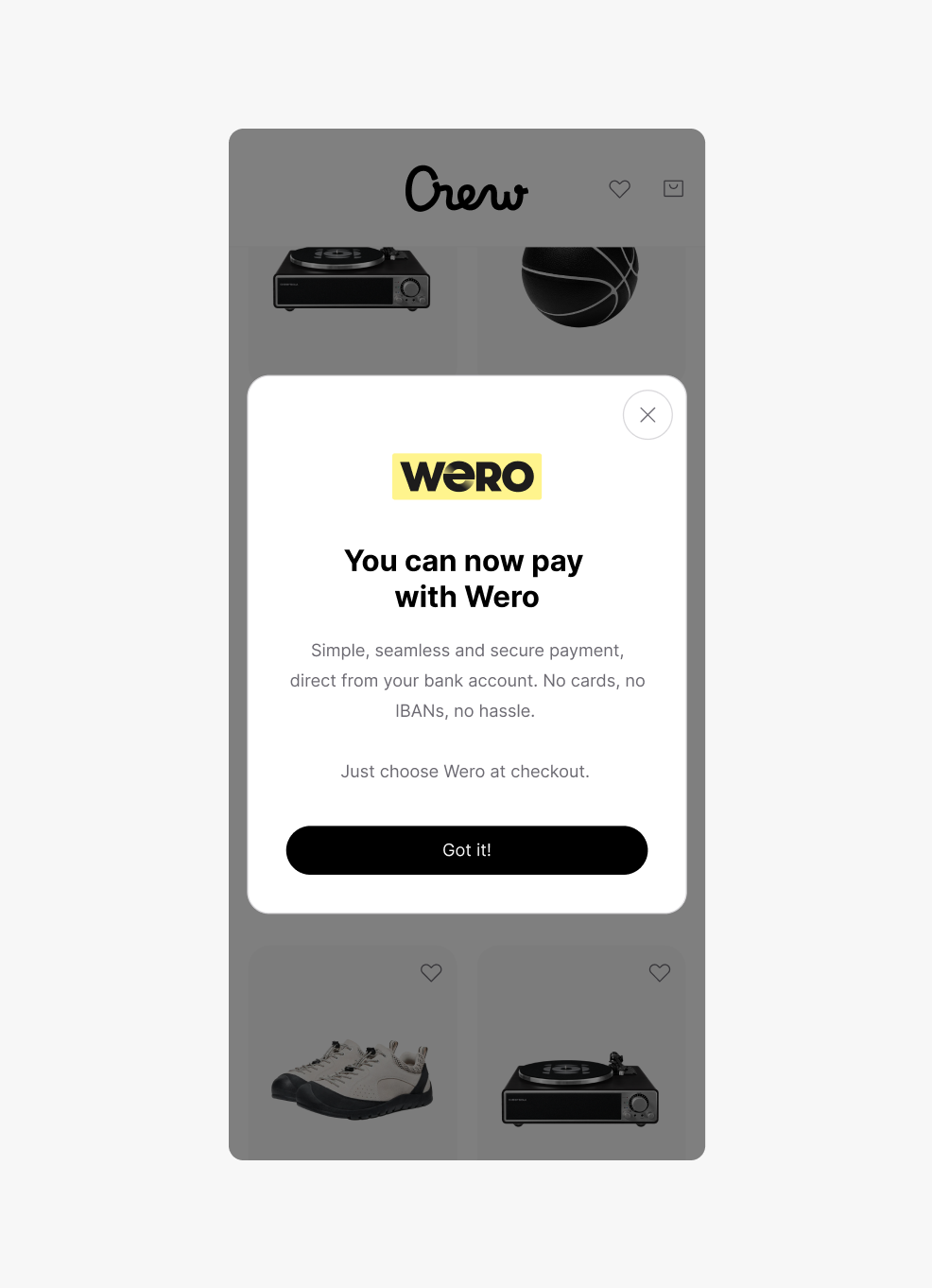 A mobile app interface for 'Crew' with a dark overlay and a central white pop-up. The pop-up features the Wero logo and the heading 'You can now pay with Wero', followed by an English description of its benefits and a black 'Got it!' button.